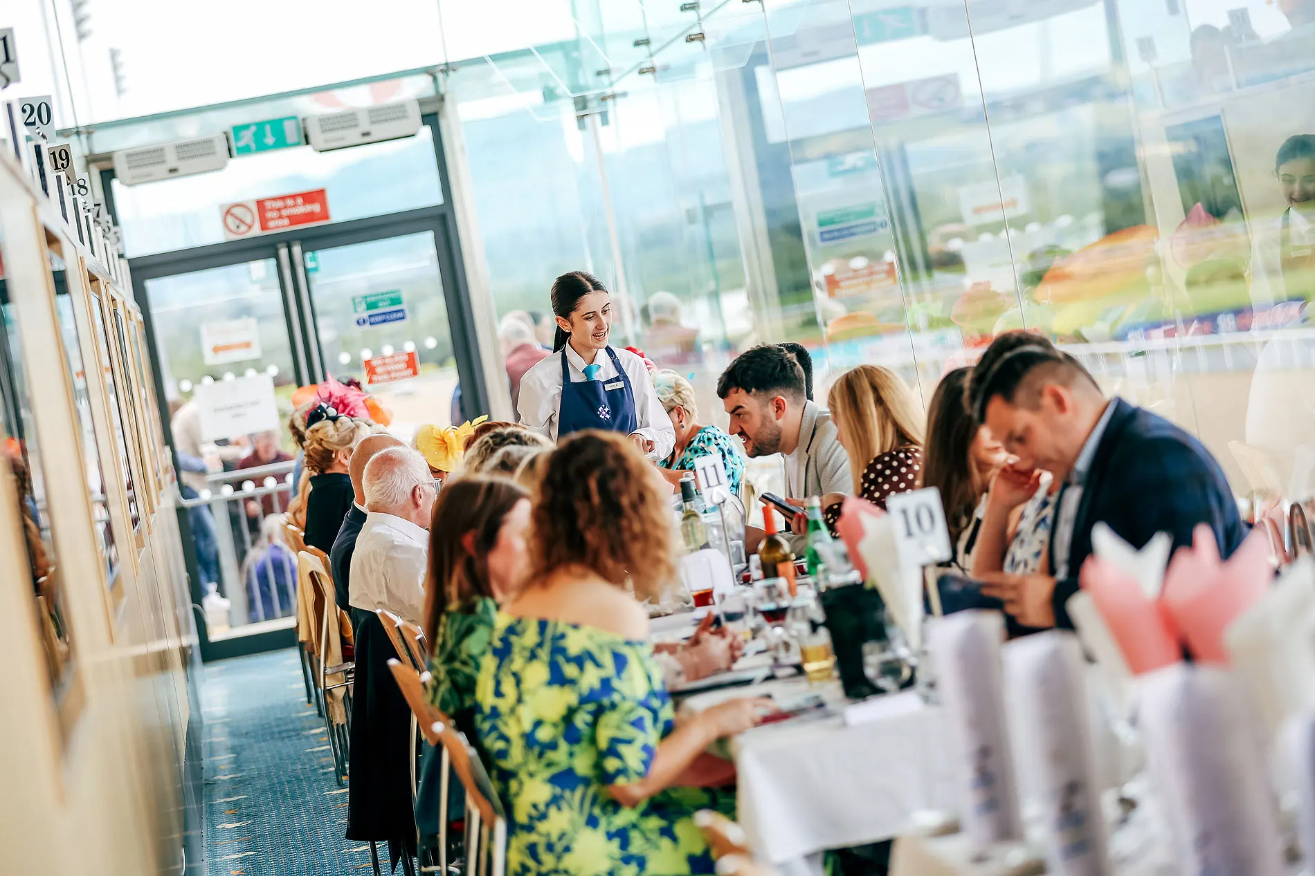 Diners at The View Restaurant, the track through the glass behind them.